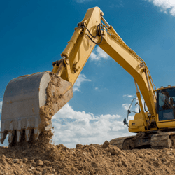 A photograph of an excavator moving dirt.